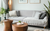 A gray couch with two fashionable wood coffee tables