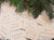 Ripped old papers that have resolutions written on them in pencil, with garland/holly strewn about sitting at the top of the photo.