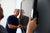 Two men mounting a TV on a TV mount