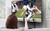 Woman on a couch, facing a tv with remote in hand while an American football game being played on the MM815, a full motion motorized tv wall mount